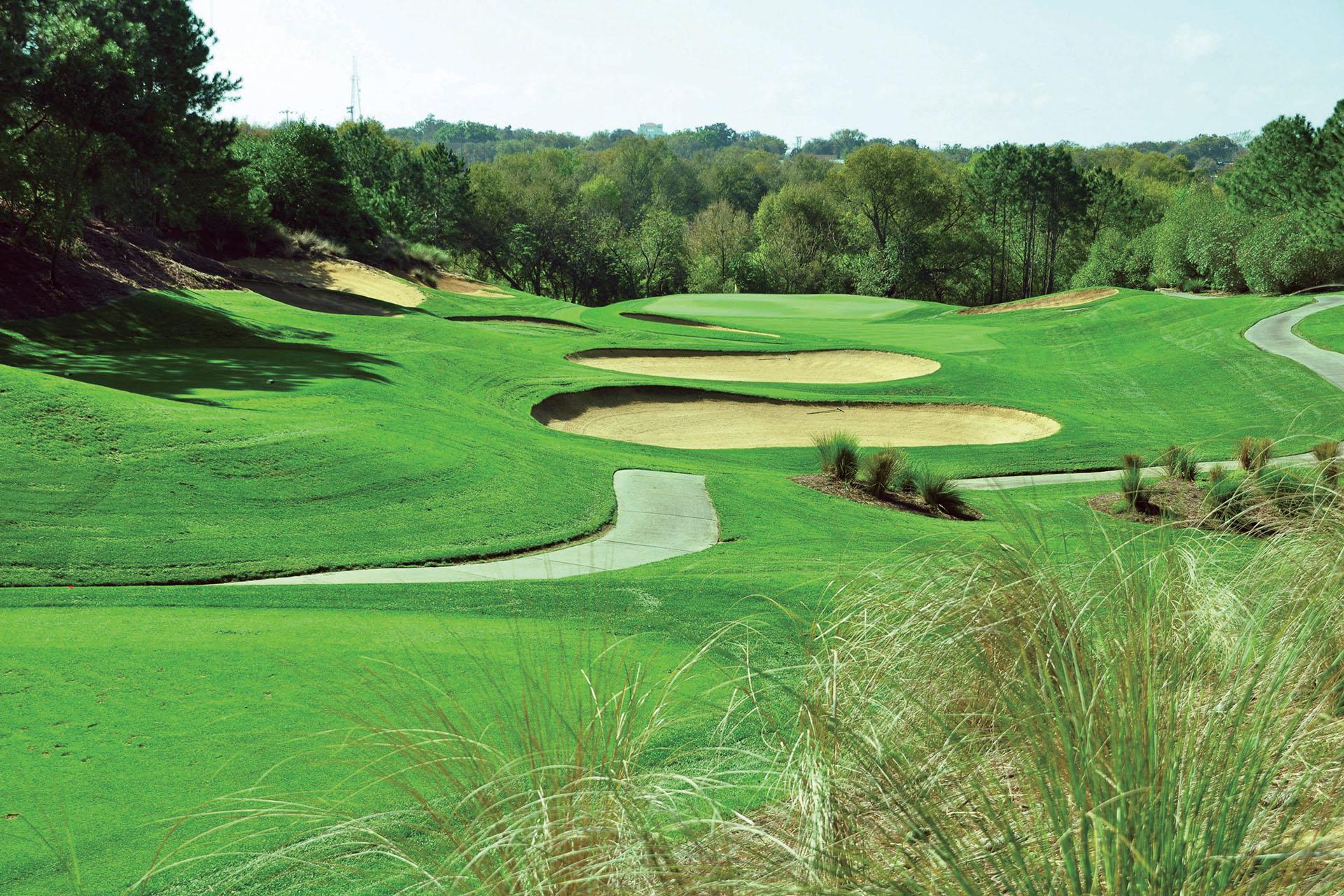 Elevated fairway with multiple strategically placed bunkers protecting the green.