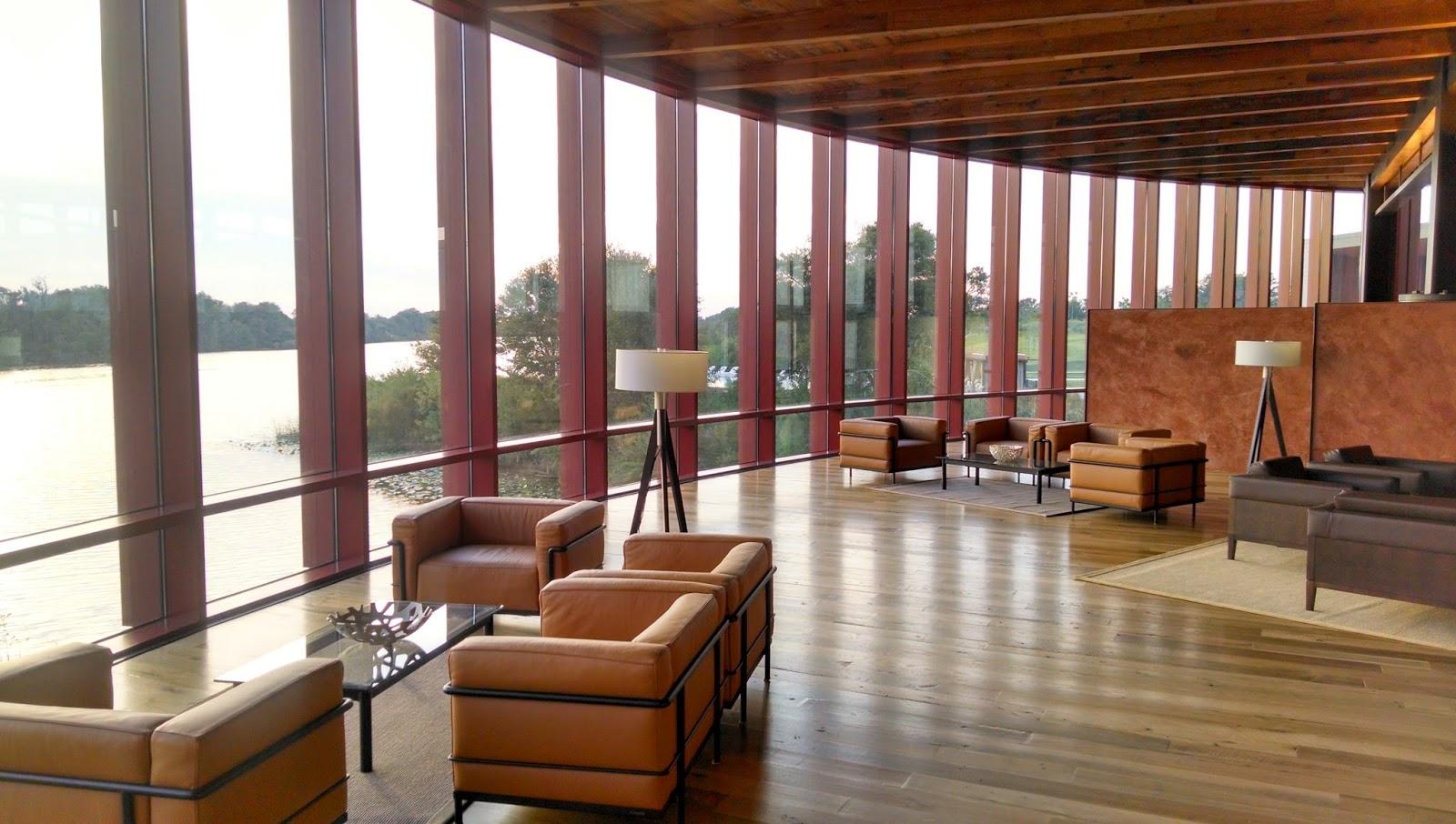 Lounging area at the resort with a panoramic window with lovely views of the lake