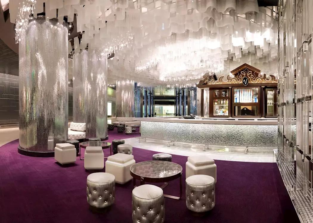 Indoor grand bar in the hotel with purple carpet and grand pillars