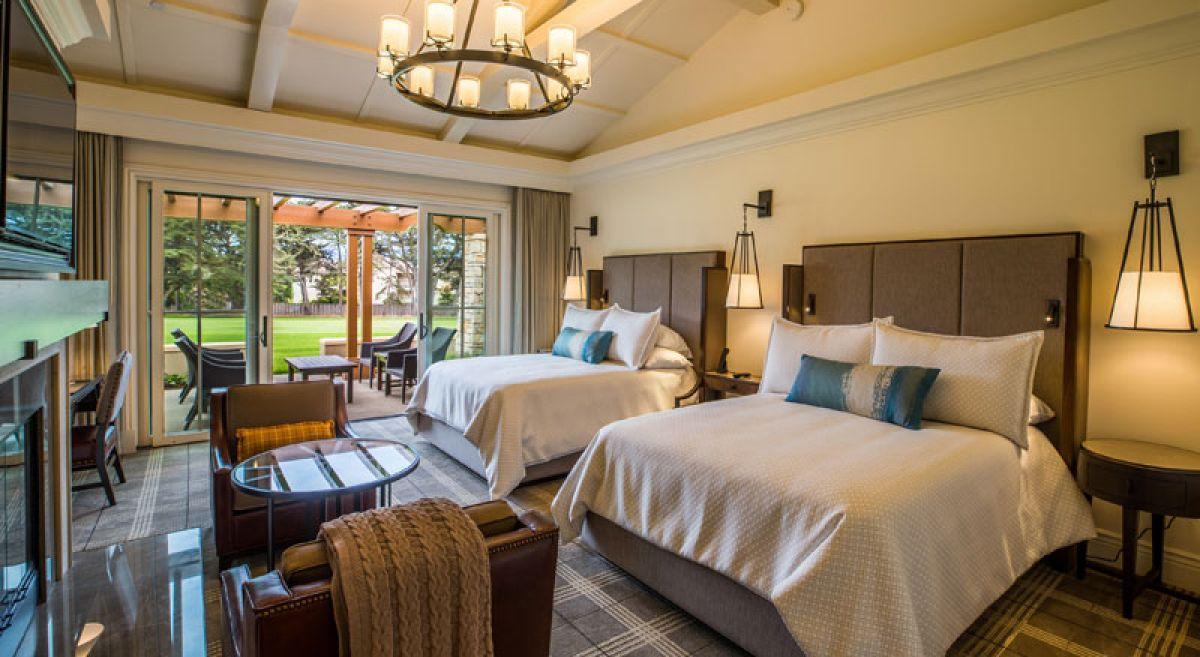 Twin double bed suite at the course featuring a grand chandler with patio seating