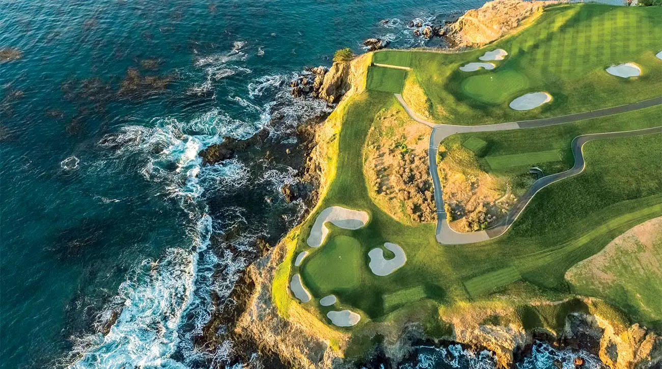 Birds eye view of the course with a walk path which leads to a green just on the edge of the island surrounded by bunkers