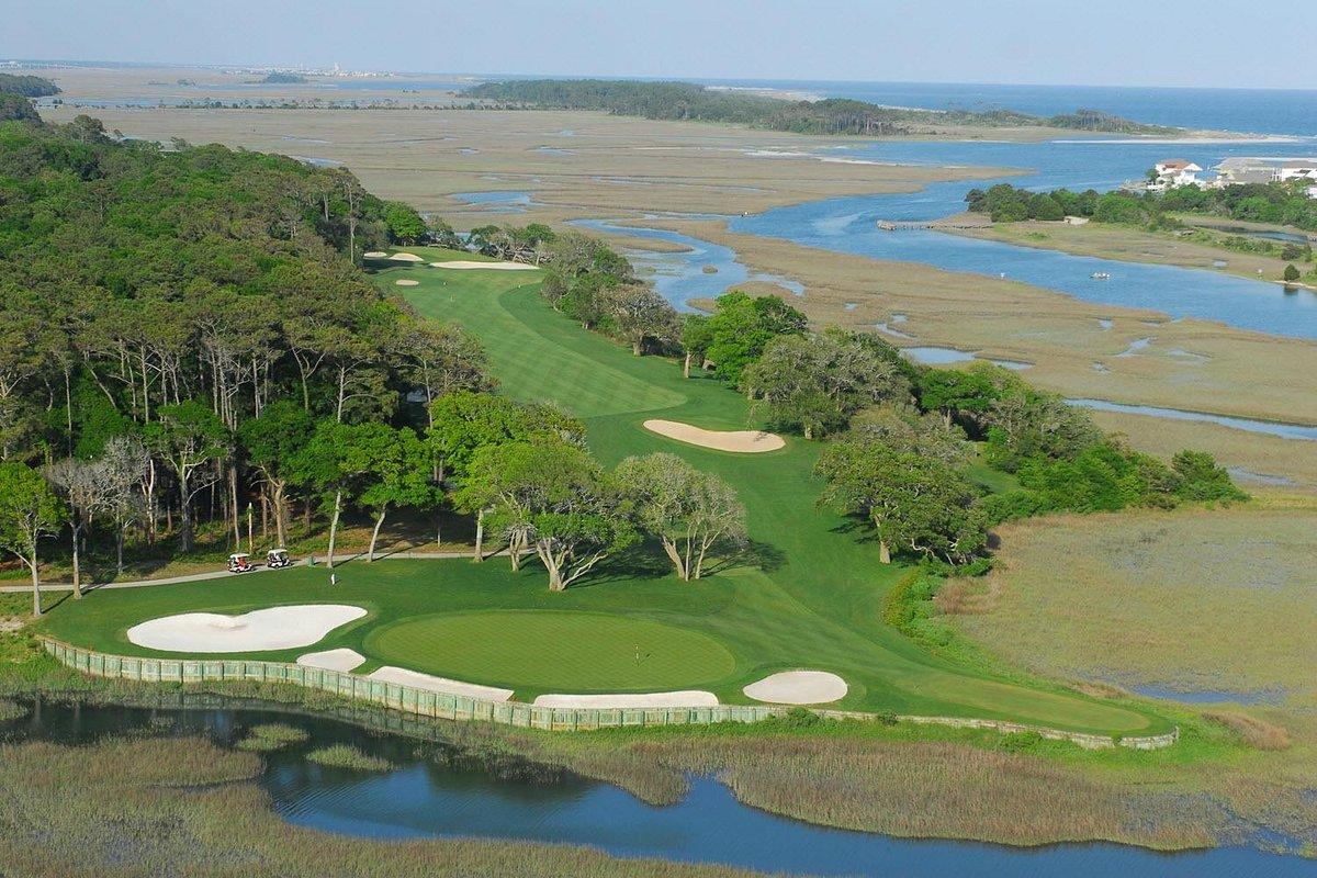 Overhead view of a manicured fairway surrounded by sand bunkers