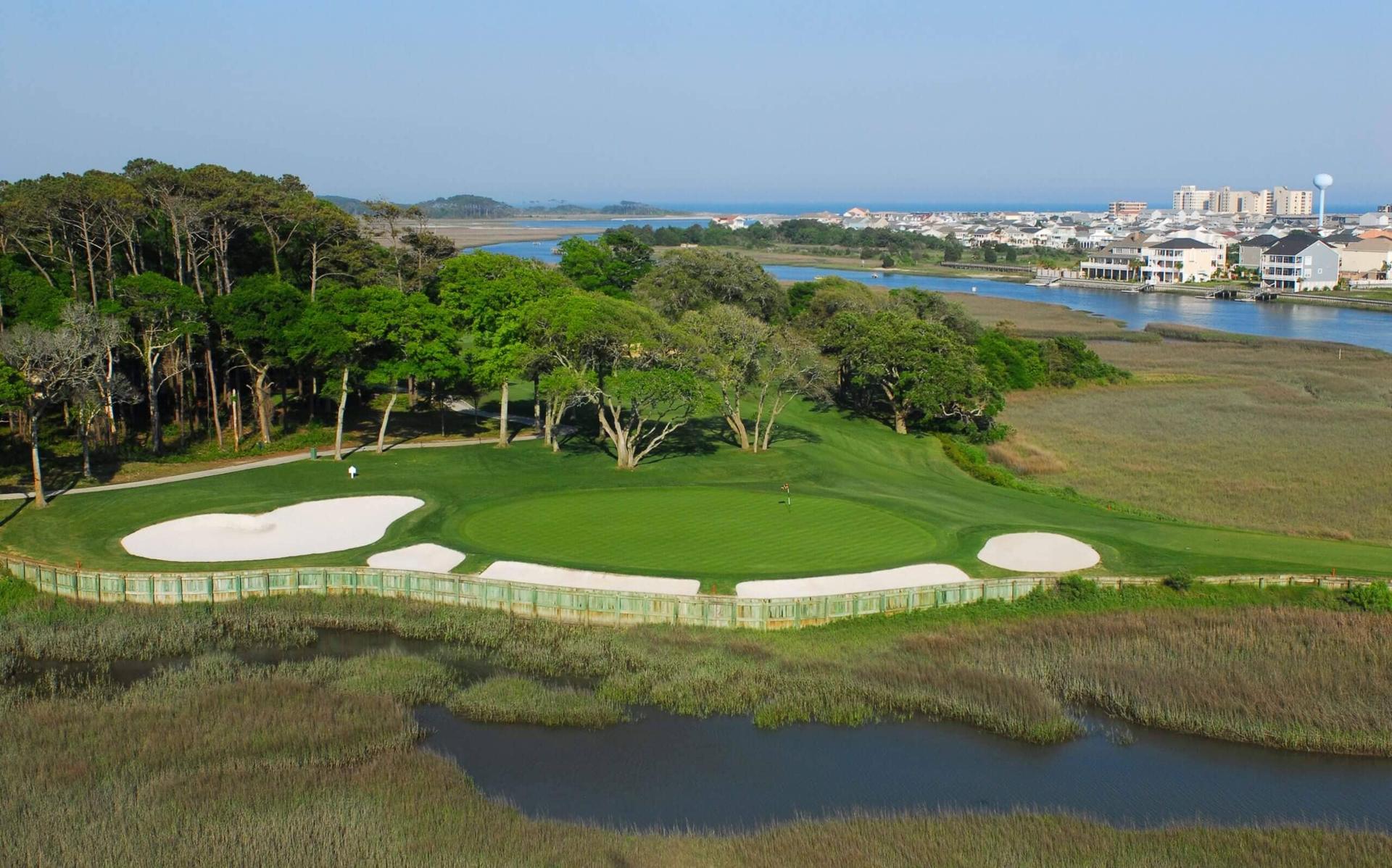 Overhead view of a smooth green elevated from a water hazard