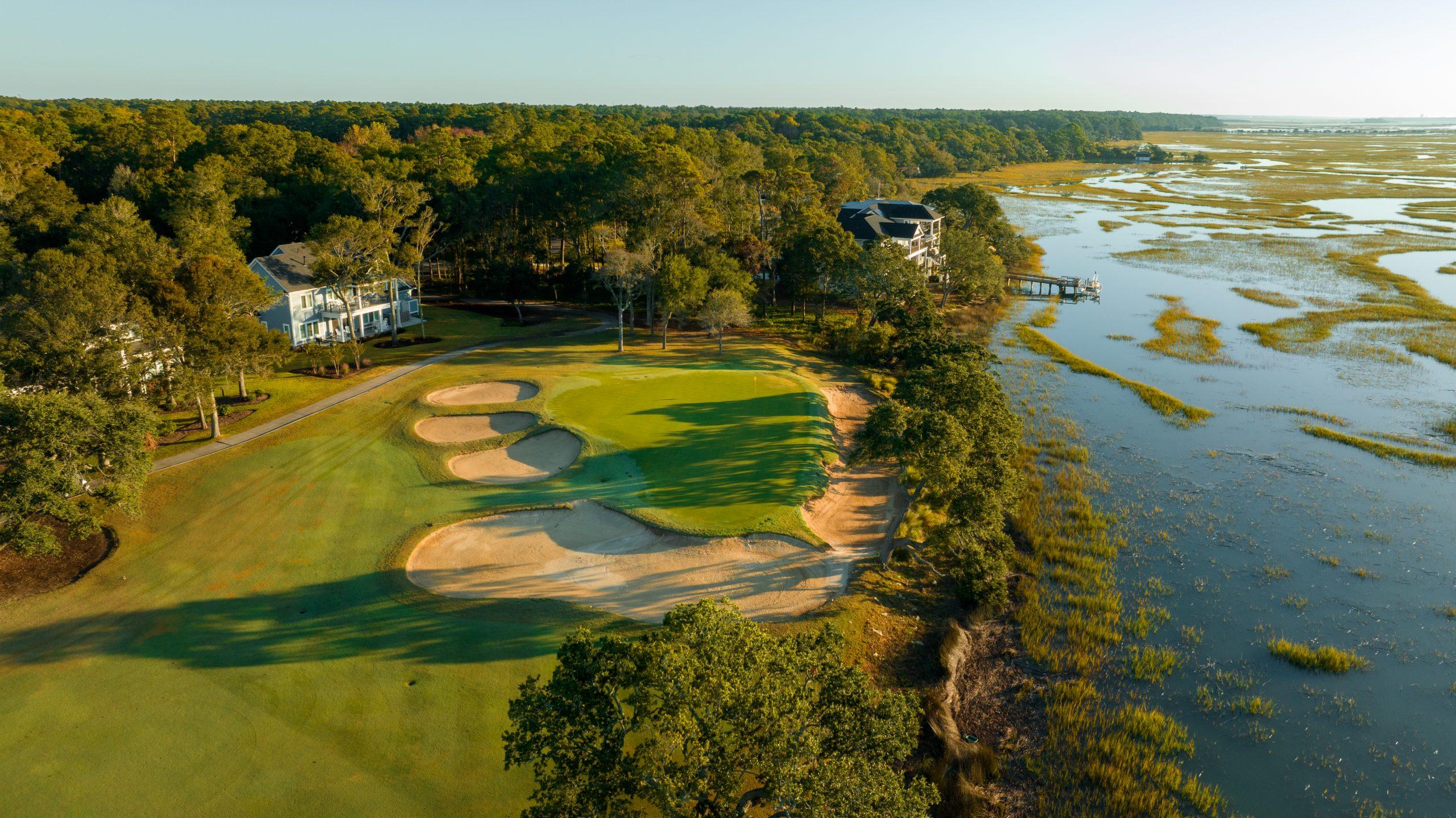 Birds eye view of a smooth green surrounded by sand bunkers