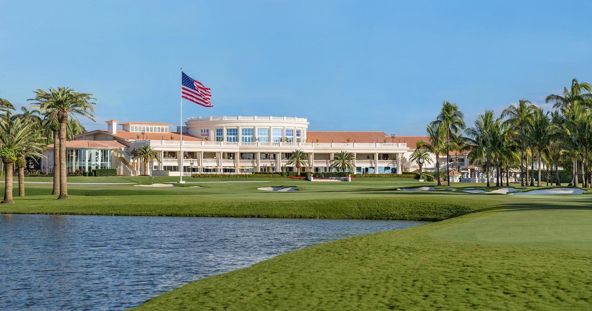 American flag swaying over the course with the Trump National Doral clubhouse looking over