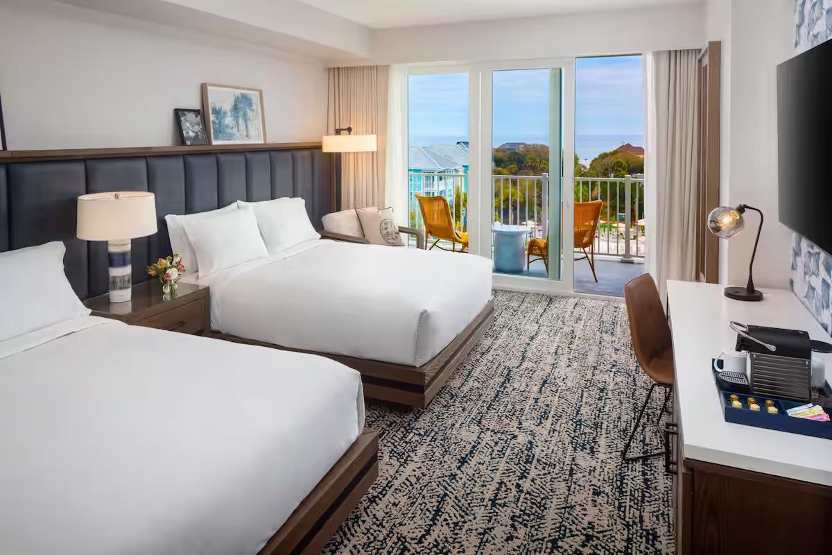 Modern twin double bed suite at the course with balcony views of the sea