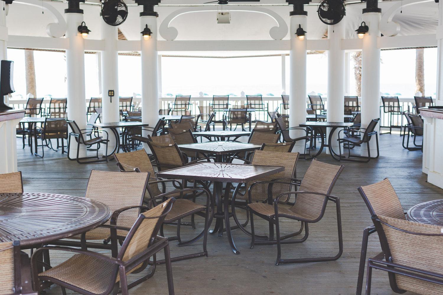 Outdoor dining room at the resort with panoramic views of the course