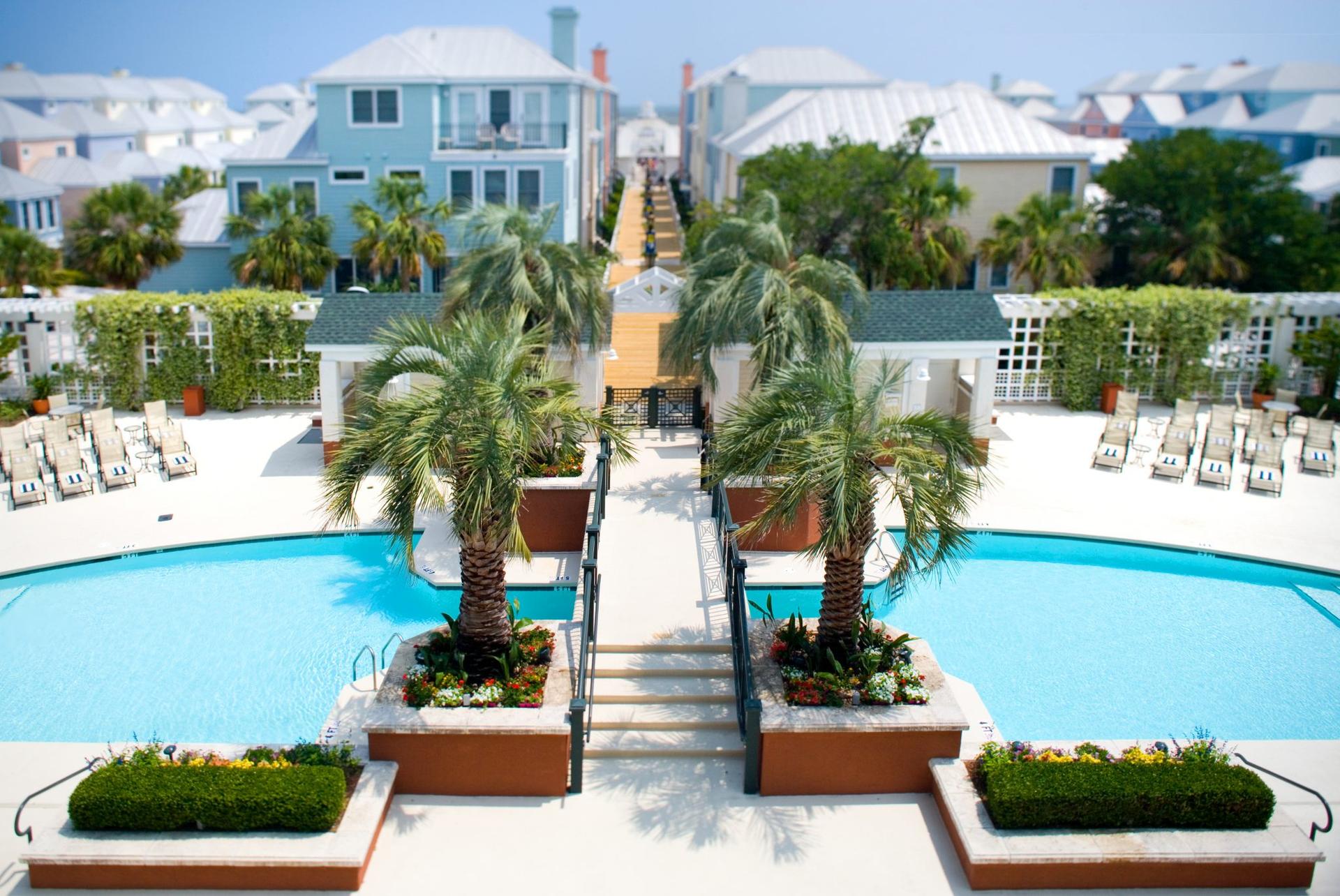 Bridge going over a swimming pool at the course leading to a walkway that will direct you to the beach