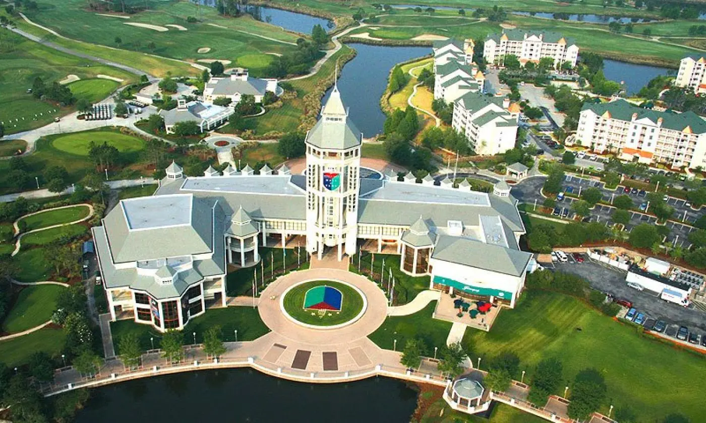 Aerial shot of the resort building with there logo chiselled into the resort and also on the front garden grass