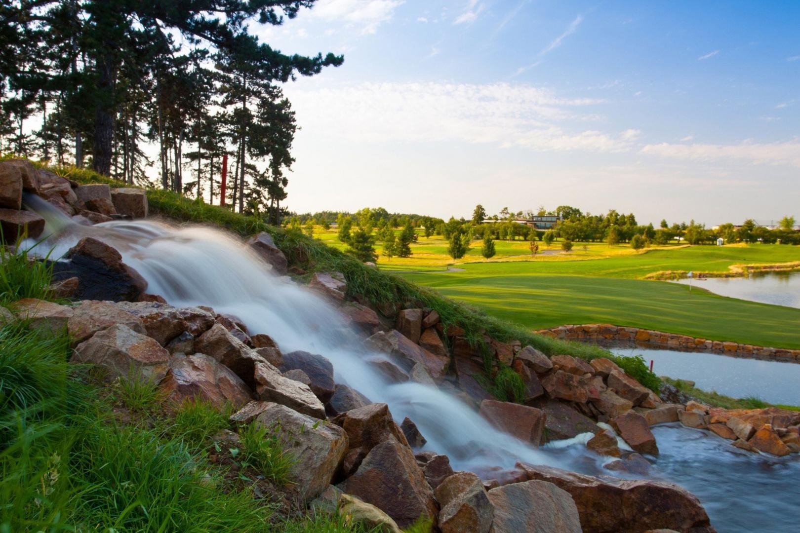 A rocky waterfall leading ti a water hazard on the Albatross Golf Resort course