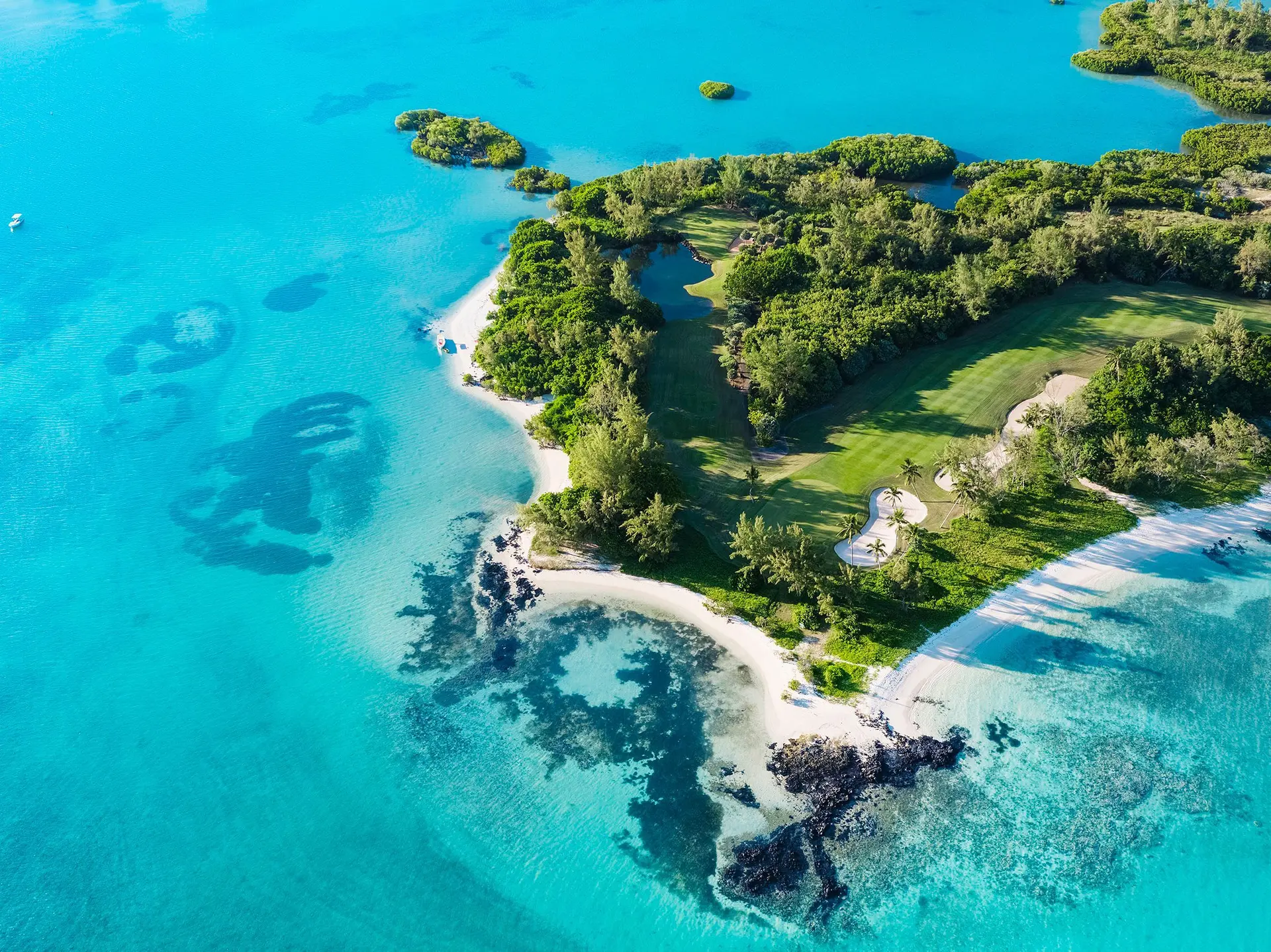 Aerial view of the Ambre Resort & Spa golf course with coastal views