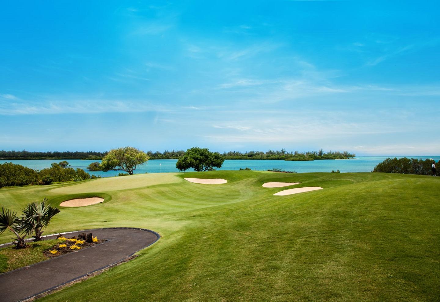 A smooth green littered with sand bunkers and coastal views at the Anahita Golf & Spa Resort