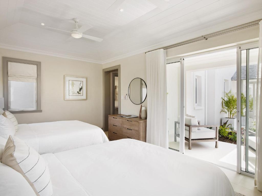 Twin double bed room at the resort with a white modern design