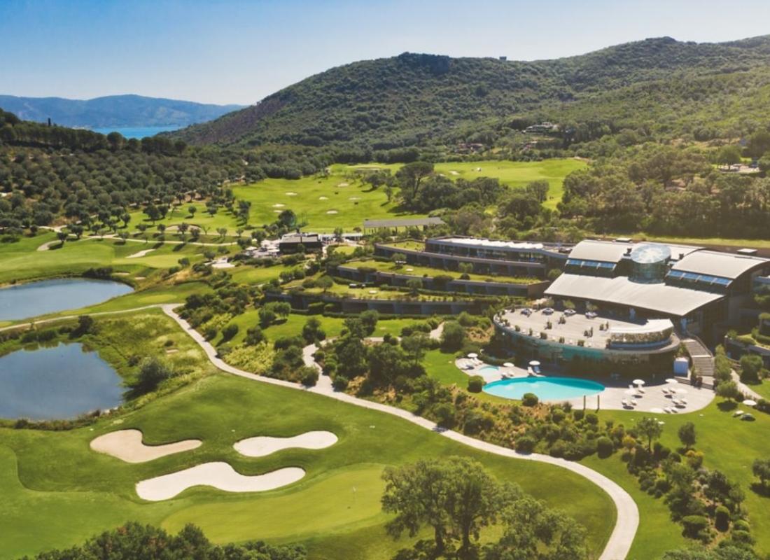 Overhead view of the Argentario Golf & Wellness Resort with an outdoor swimming pool looking out onto the course