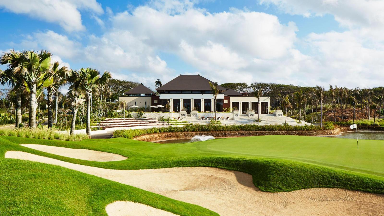 The Bali National Golf Clubhouse overlooking a smooth green surrounded by sand bunkers