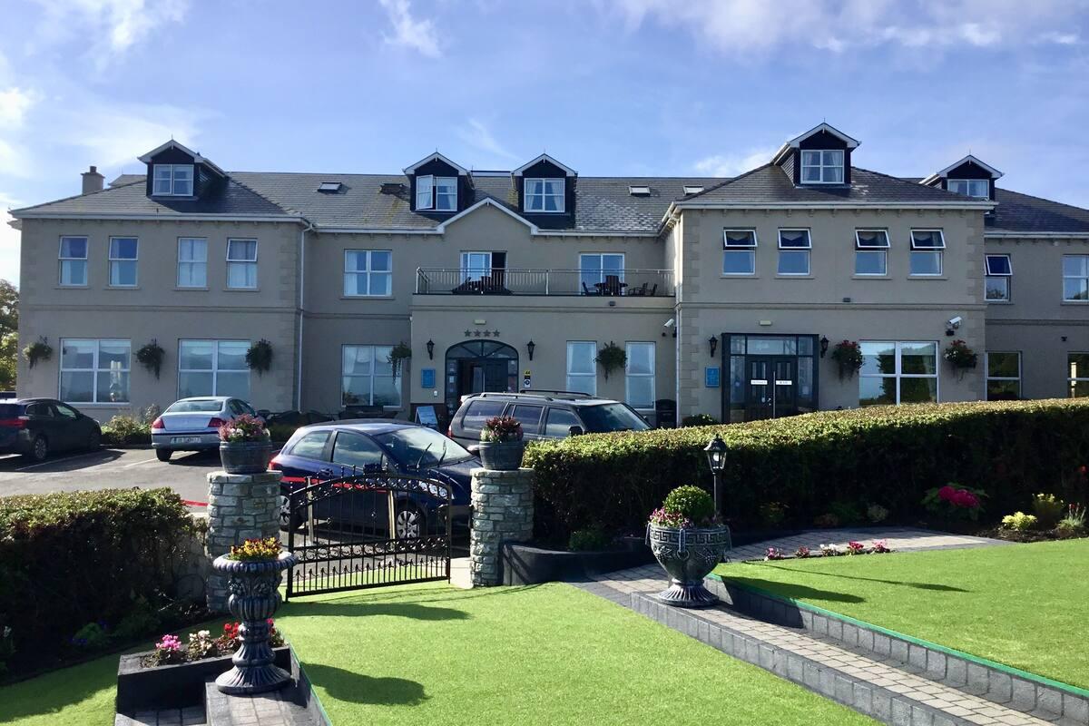 Closer angle of the modern Ballylifin lodge showing its parking availability