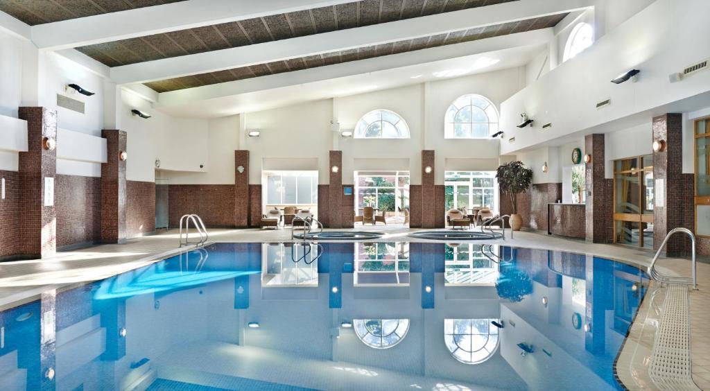 Indoor swimming pool and Jacuzzi's at the hotel with windows bringing in lots of natural light
