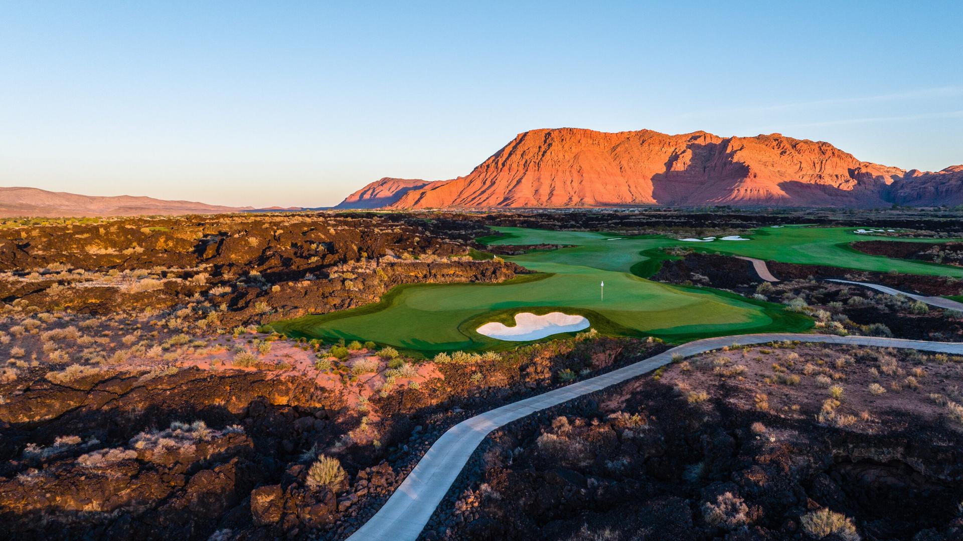 Sun setting over the Black Desert golf course with a mountain is the distance