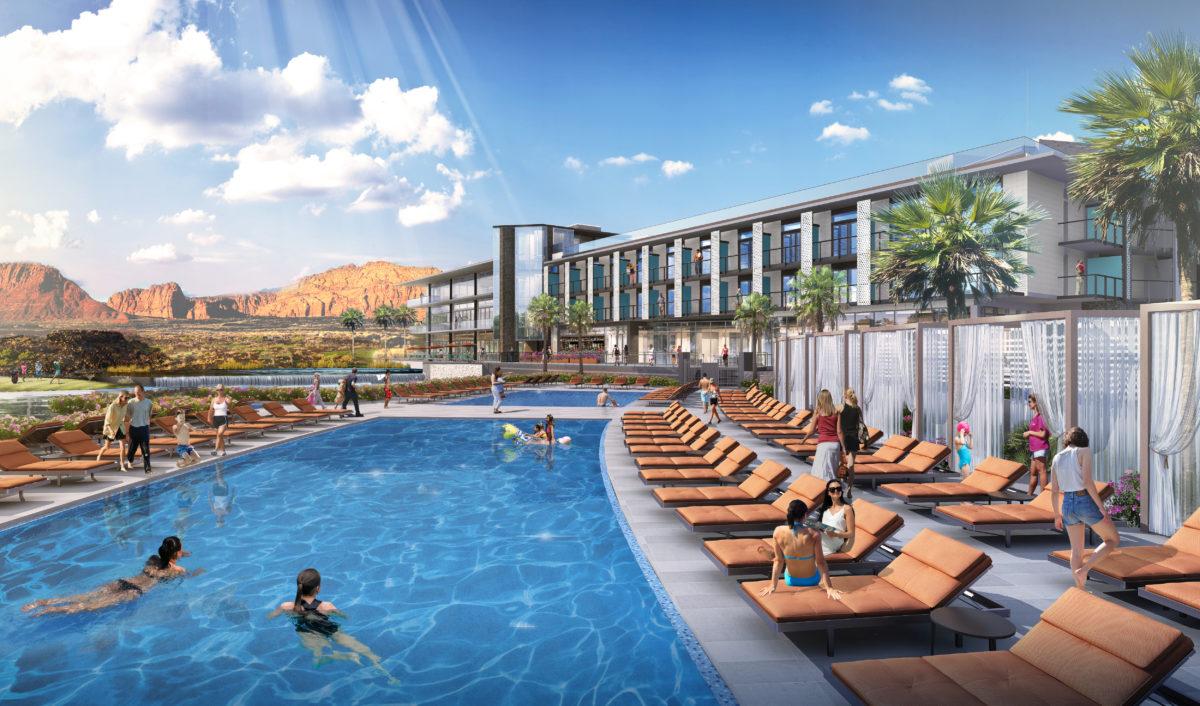 Outdoor swimming pool at the course equipped with sunbeds and mountain views in the distance