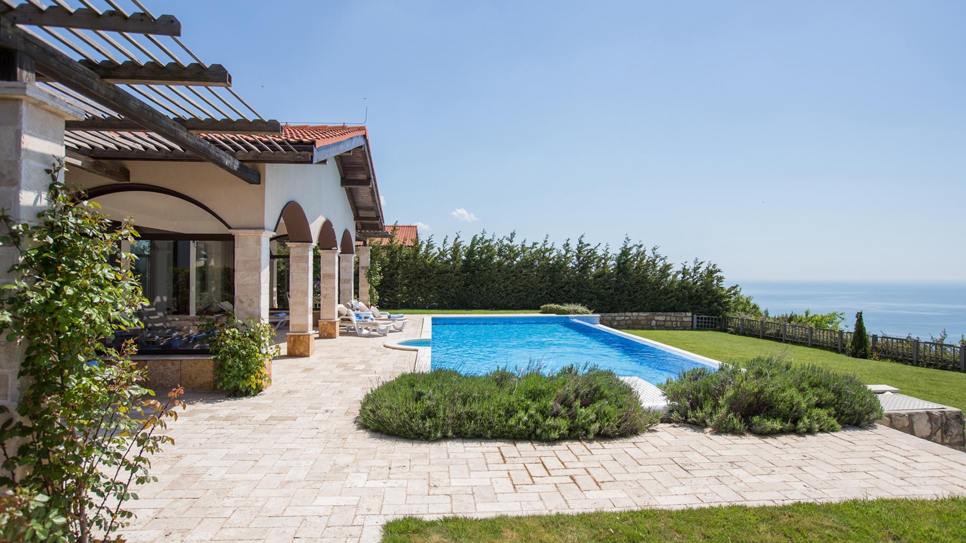 A personal pool as part of a villa at the BlackSeaRama Golf & Villas resort wuith sea views