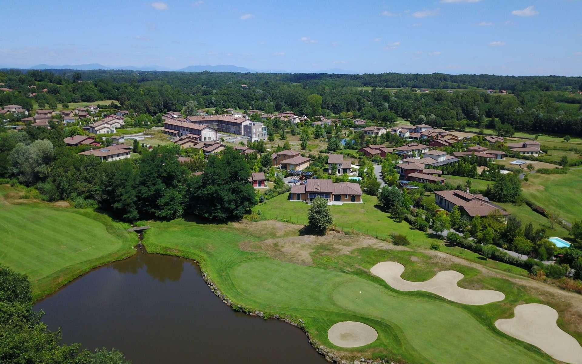 Aerial view of the course surrounded by charming villas and greenery.