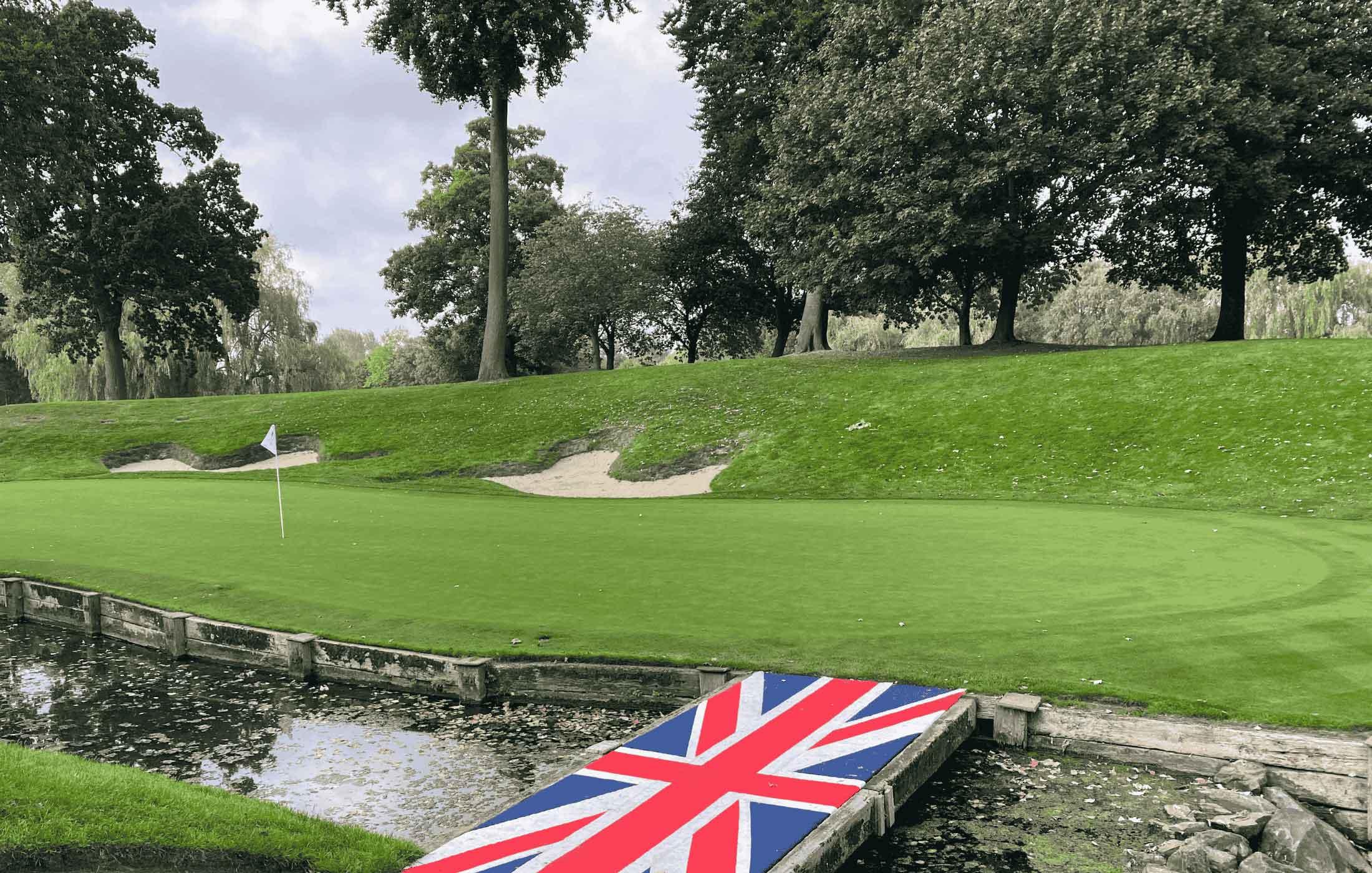 British flag acting as a walkway to navigate the water hazard strategically placed just next to the green