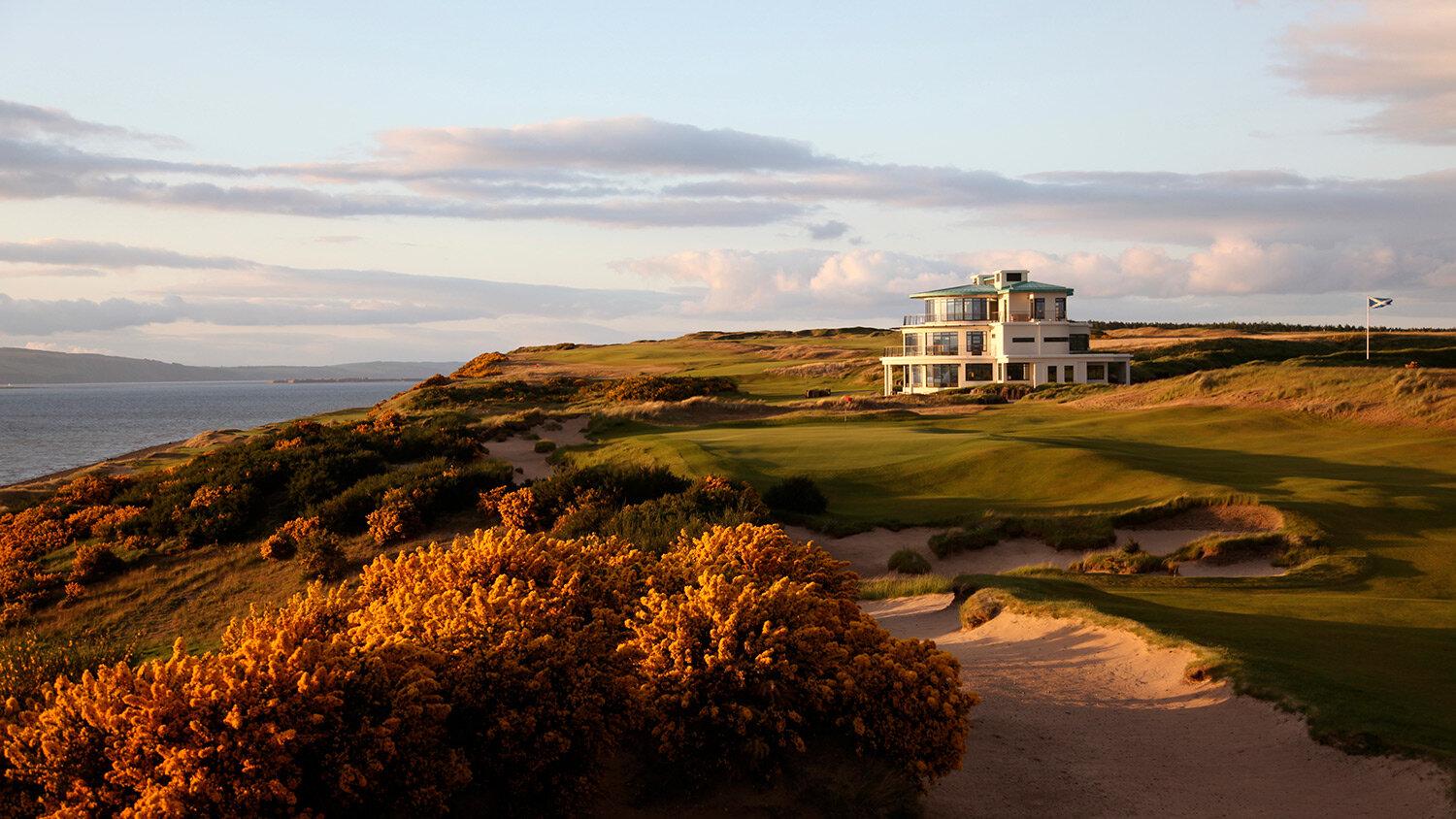 Sun setting over the cabot highlands course and clubhouse