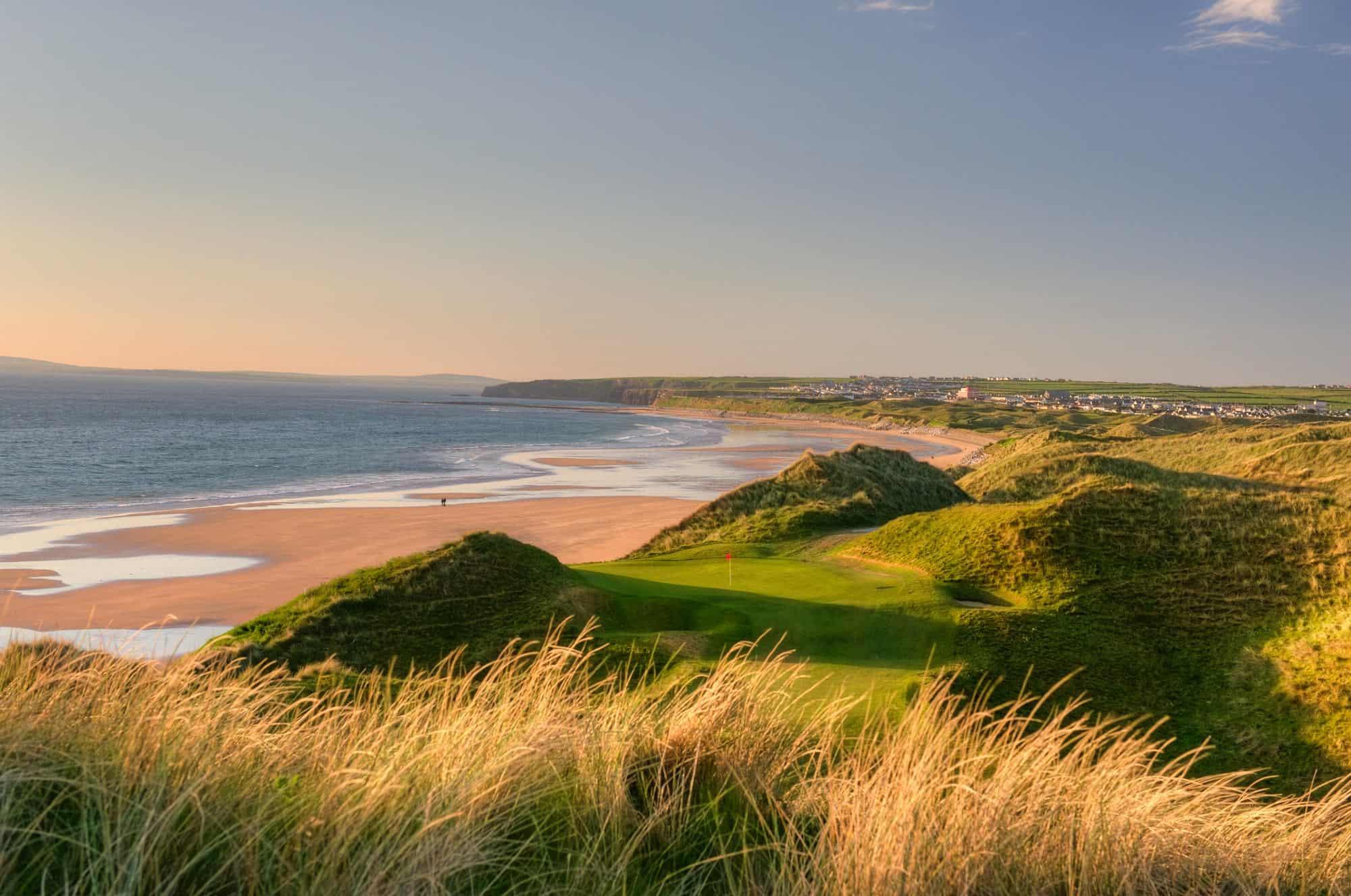 Enjoy local town views alongside a sandy beach and blue seas while on play on well kept greens