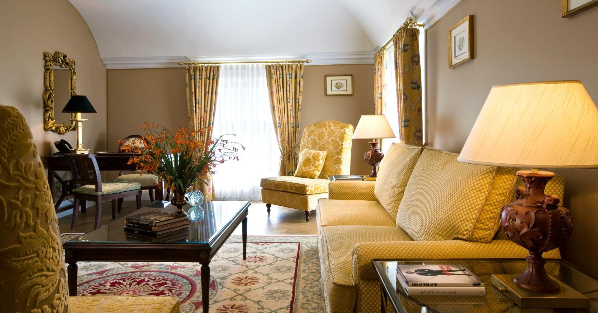 Elegant sitting room with classic decor, warm lighting, and plush furnishings for a luxurious stay.