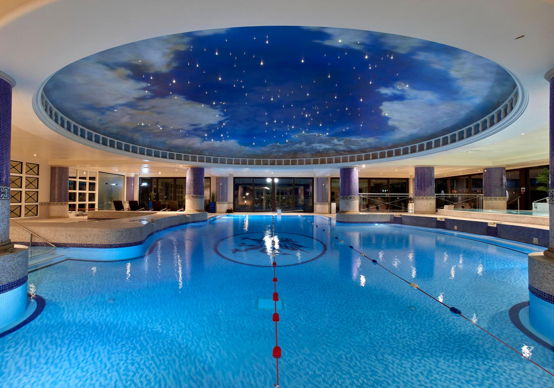 Sky blue swimming pool with stars and clouds in the ceiling