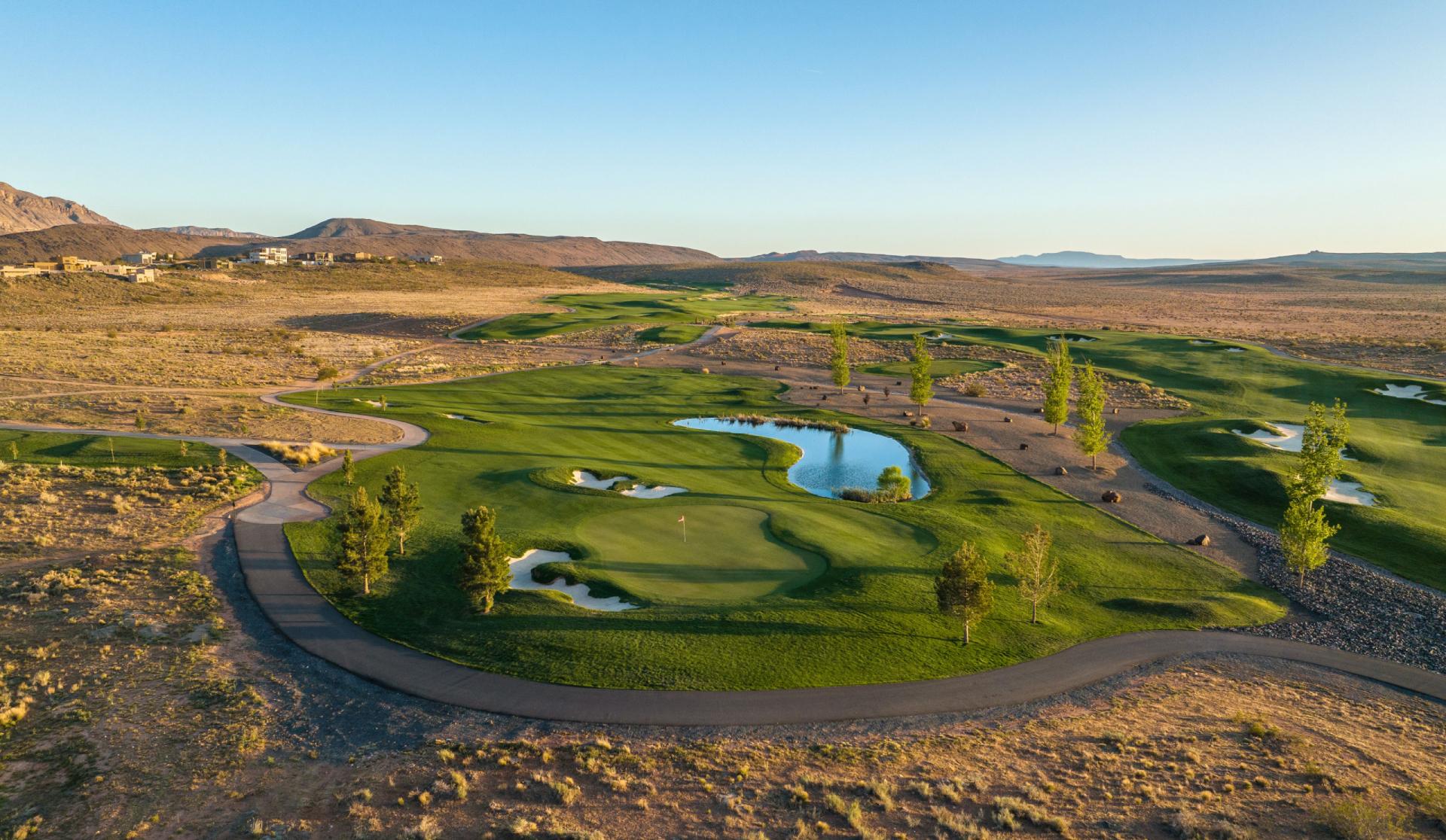 A peaceful course with water features surrounded by desert landscape.