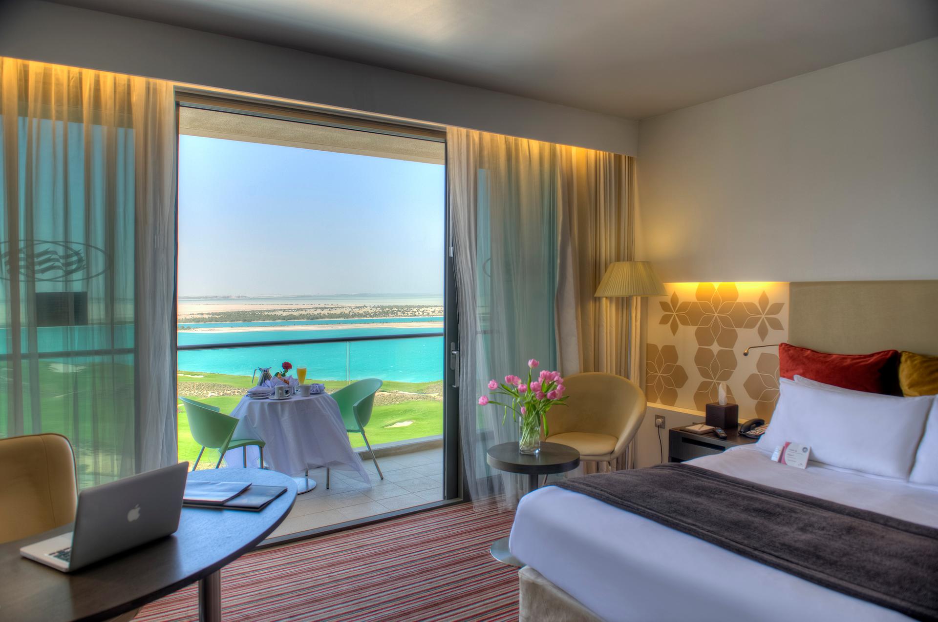 A double bed suite at the resort with balcony views of the golf course