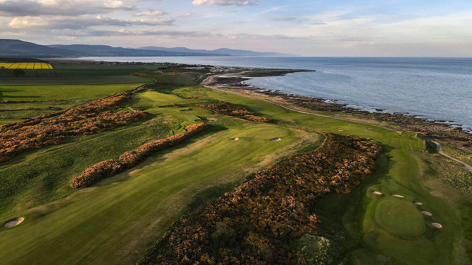 Aerial shot of rolling dunes running down the coastal line