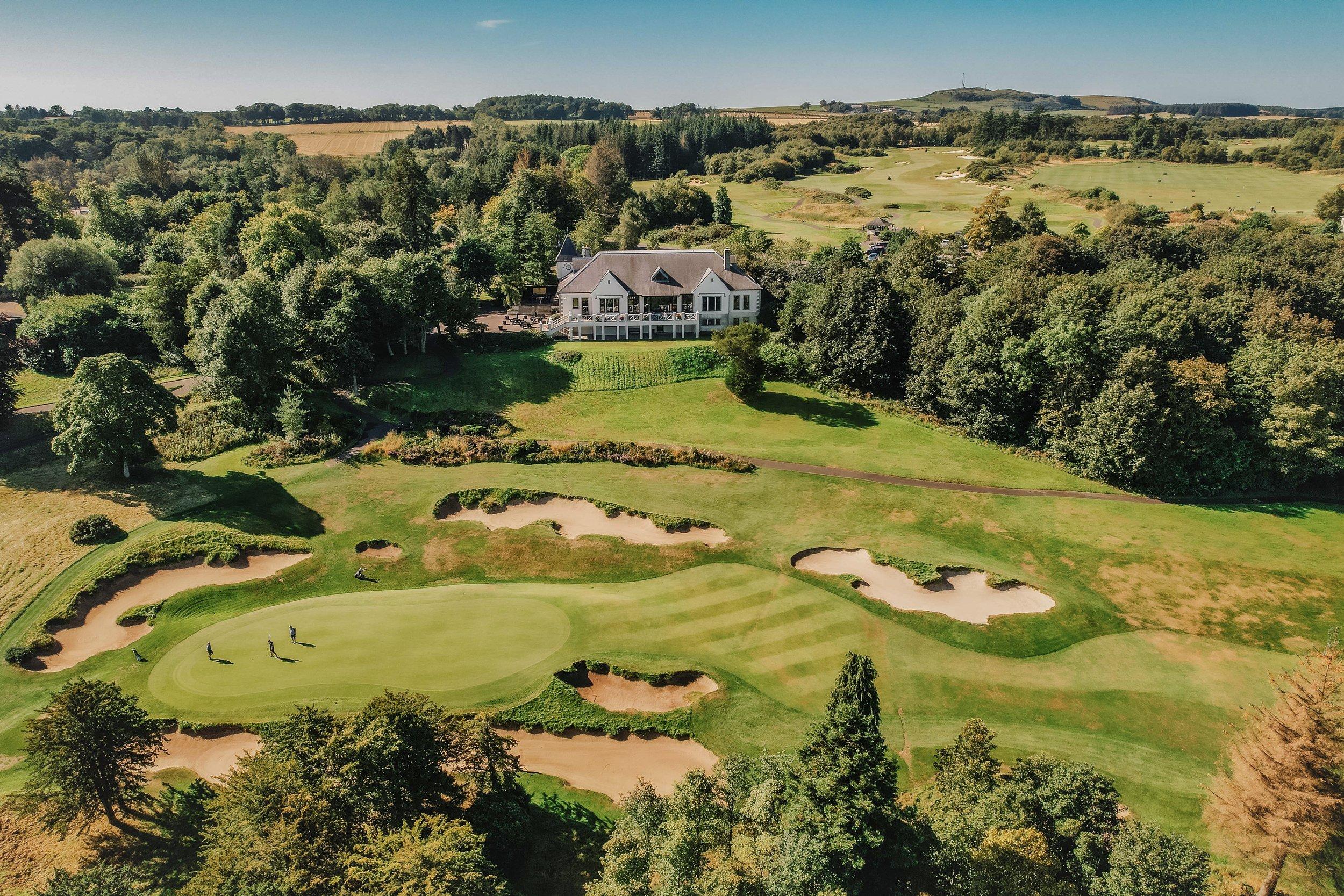 Dukes Course Clubhouse looking over golfers enjoying their round on the greens