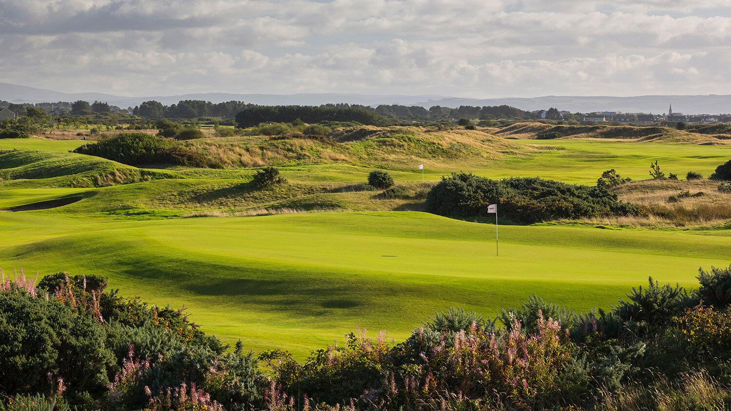 Rolling green hills stretch out under a cloudy sky at Dundonald Links.
