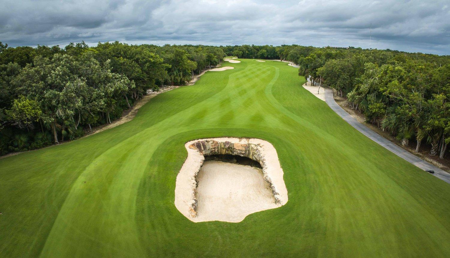 A deep natural bunker placed in the centre of a fairway