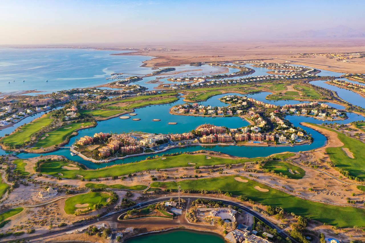 A stunning aerial view of El Gouna with lush golf courses surrounded by winding blue lagoons