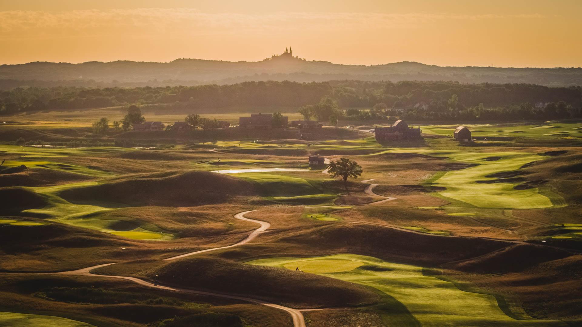Aerial panoramic view of the Erin Hills Golf Course at sunset causing shadows on the course