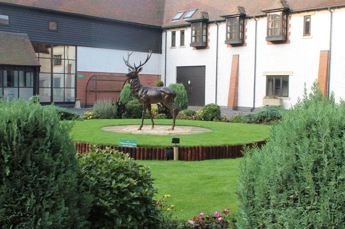 Deer statue placed on an elevated platform at the Forest of Arden
