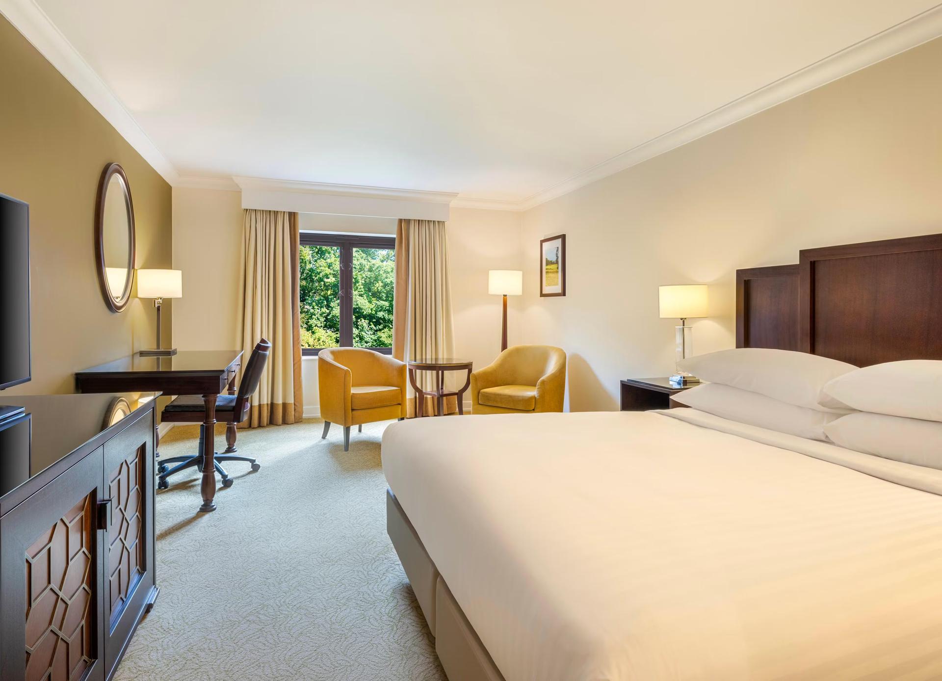 Cozy hotel room with modern furnishings and a garden view.