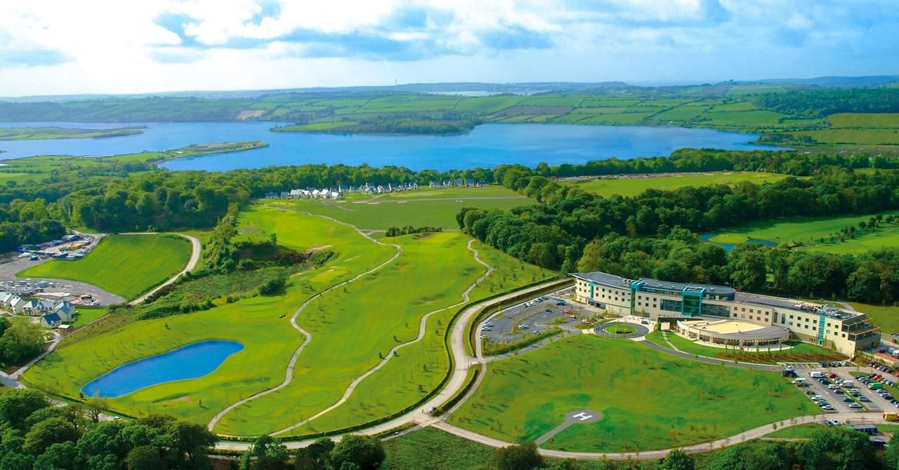 Aerial view of resort, golf course, and surrounding landscape.