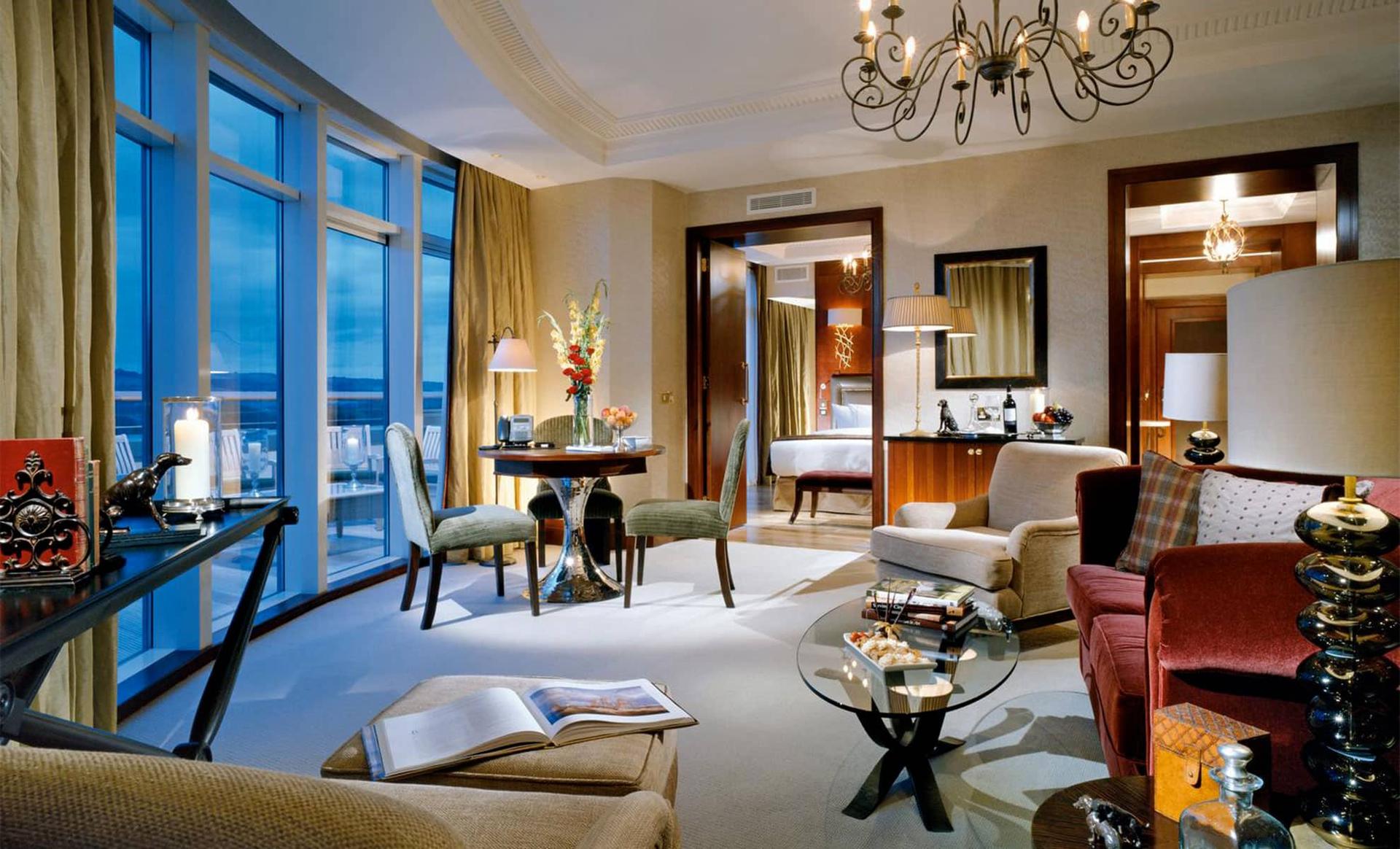Elegant suite with lounge, dining area, and bedroom.