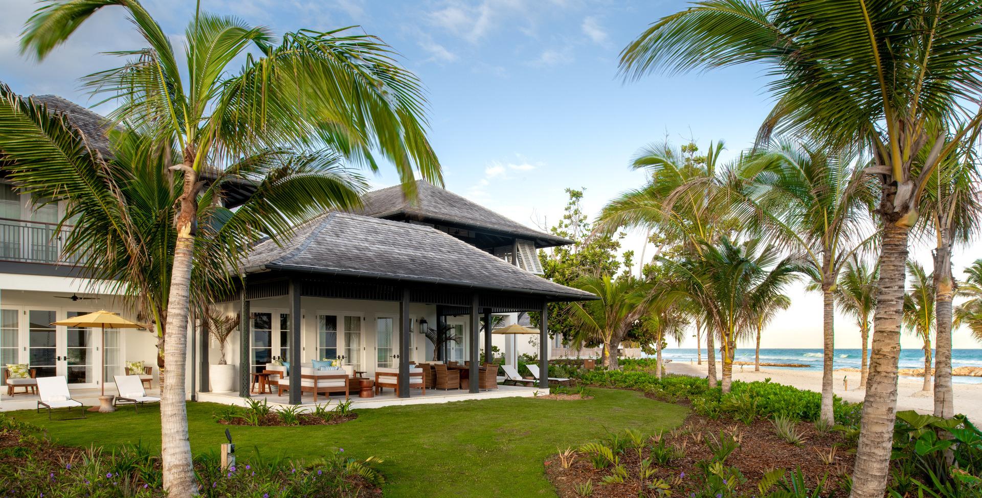 Palm trees surrounding the resort building with the beach in the back
