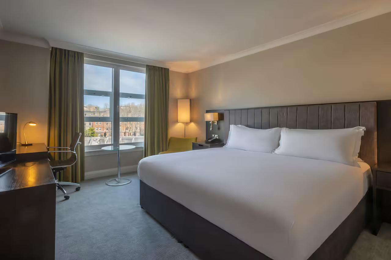 Cozy modern bedroom with a view of the city