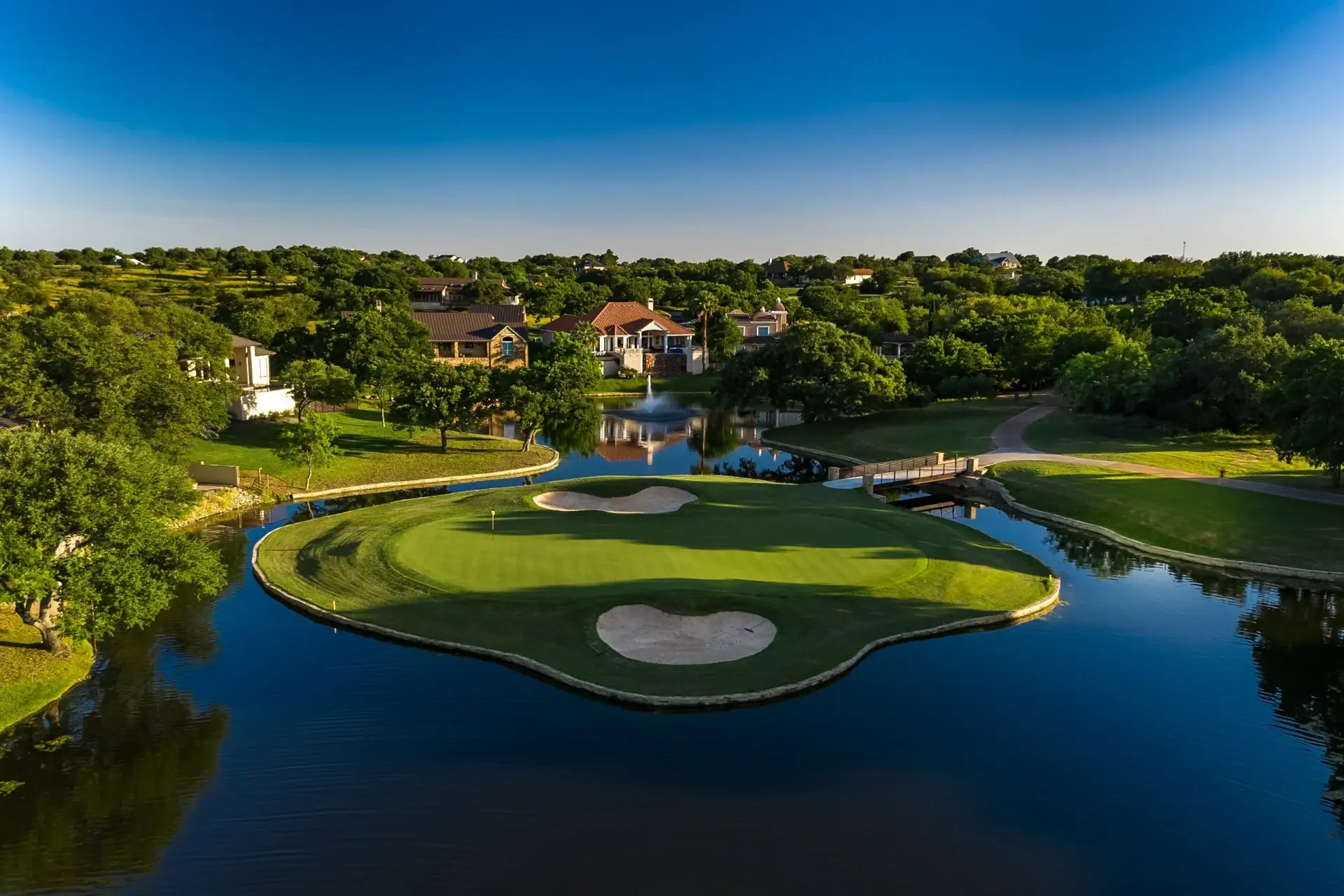 An island green surrounded by sparkling water highlights the resort’s scenic golf course.