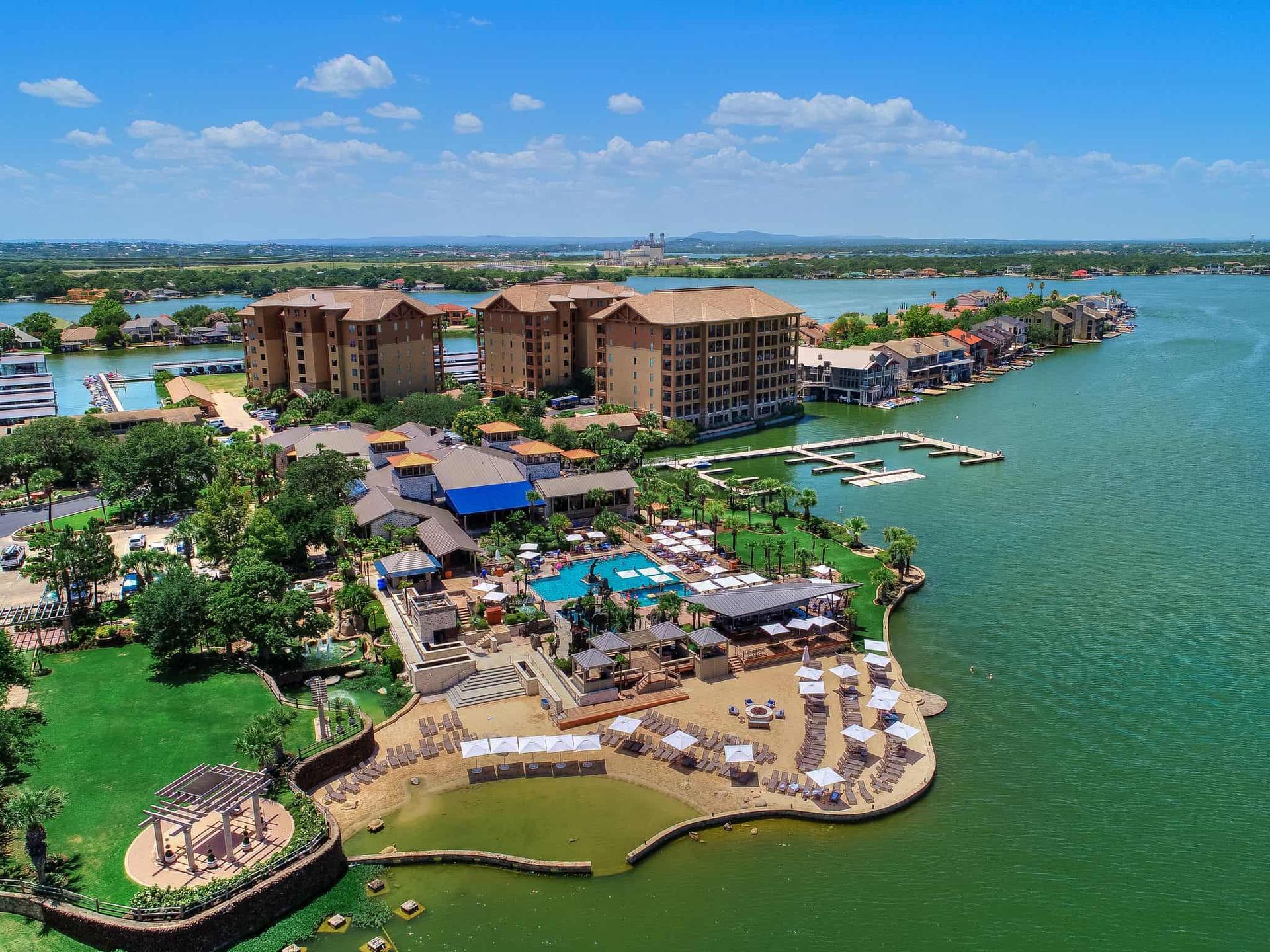 Aerial view of Horseshoe Bay Resort featuring pools, cabanas, and a marina extending into the lake.