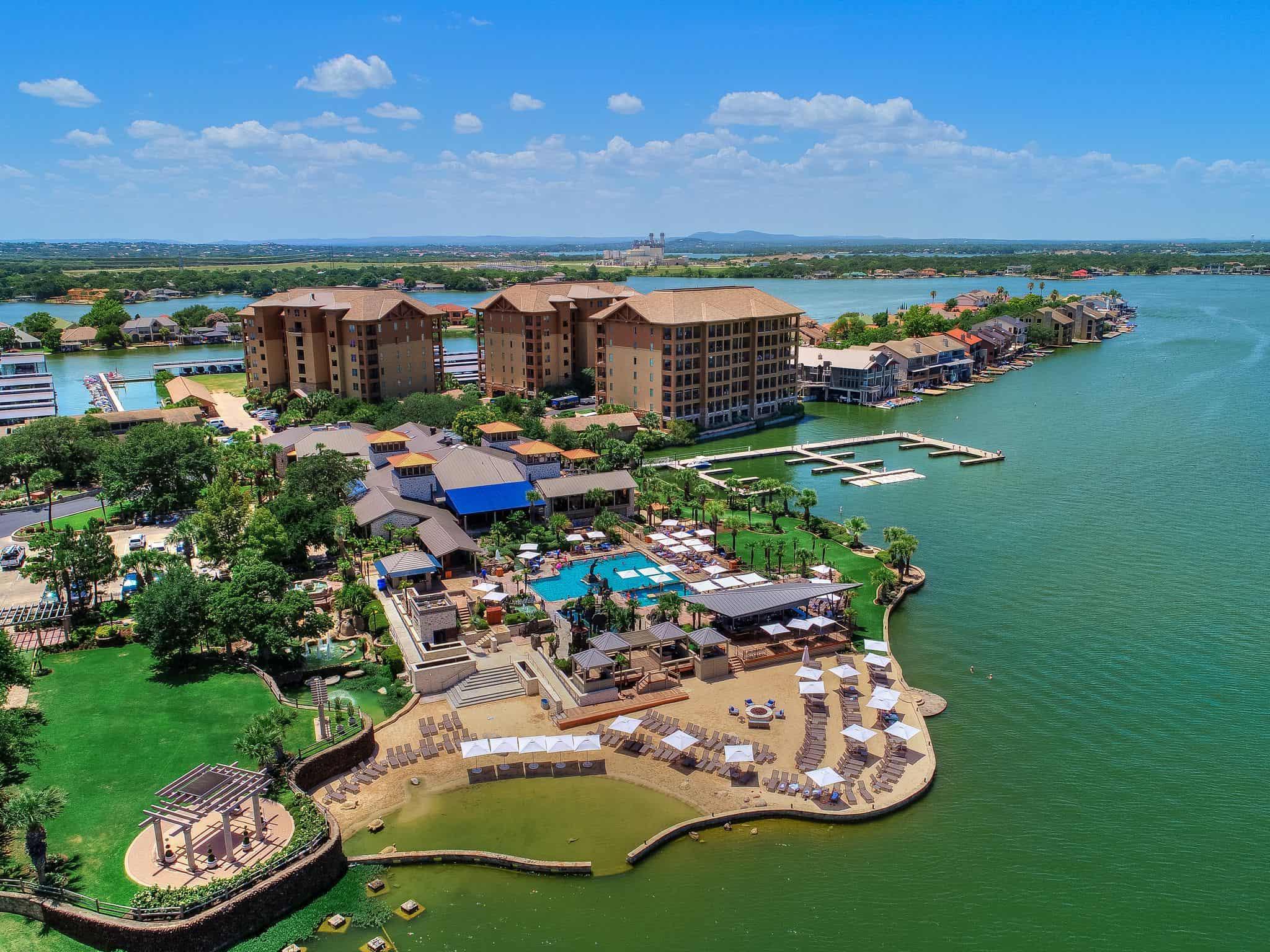 Aerial view of Horseshoe Bay Resort featuring pools, cabanas, and a marina extending into the lake.