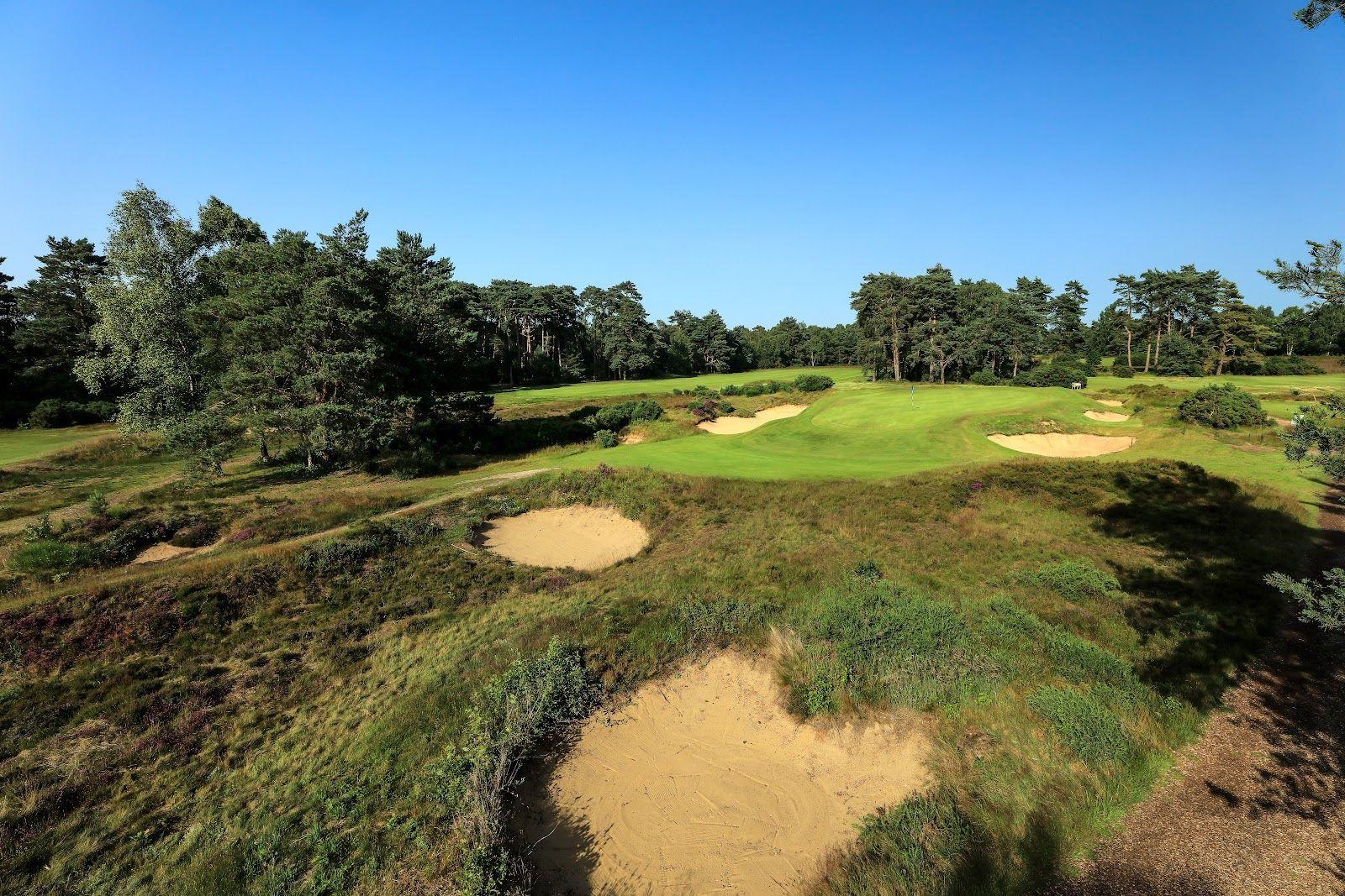 A challenging green surrounded by several deep sand bunkers.