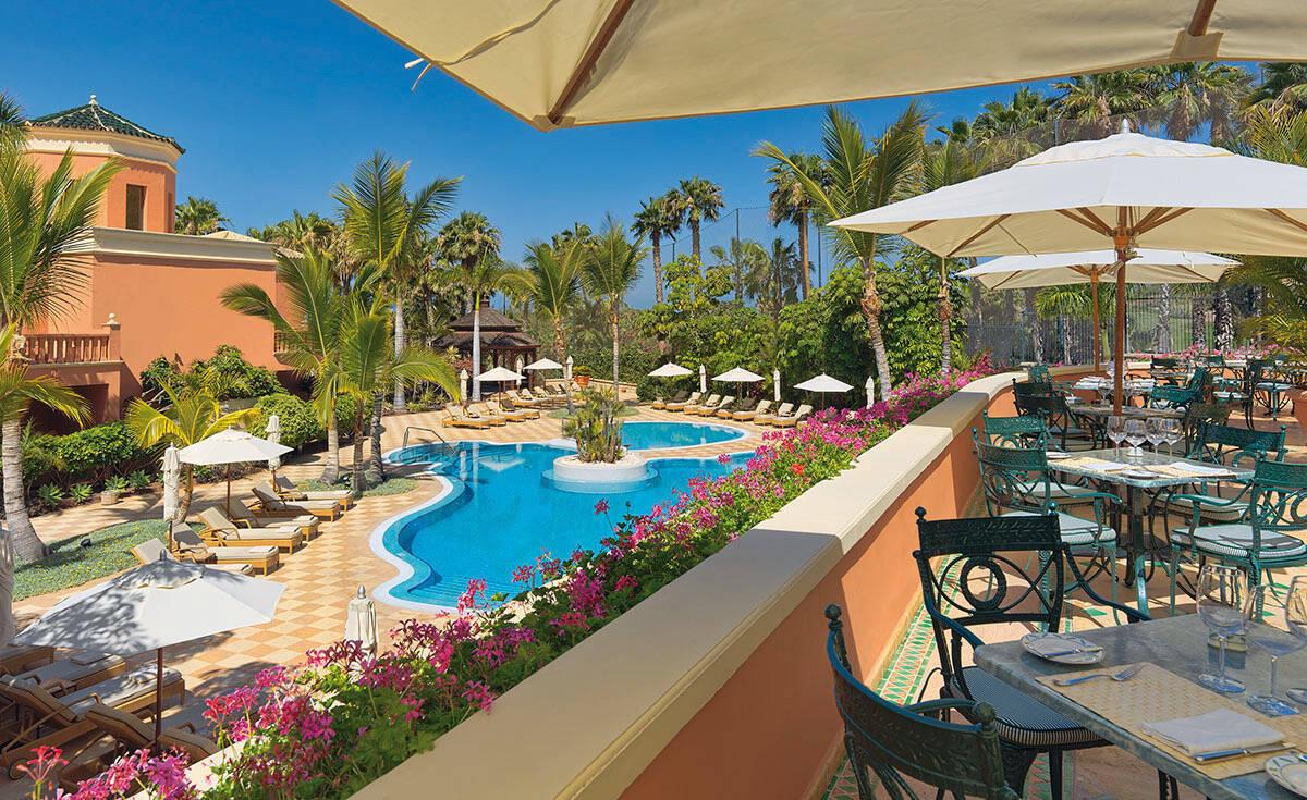 Outdoor dining area overlooking the swimming pool