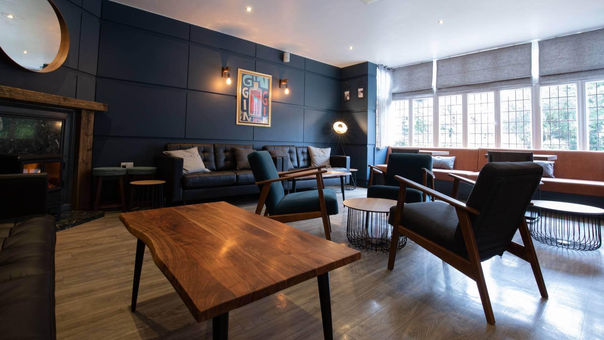 Lounging area at the hotel with fire place and various seating options